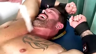 Robust hunk endures bondage and torment on half nude congress